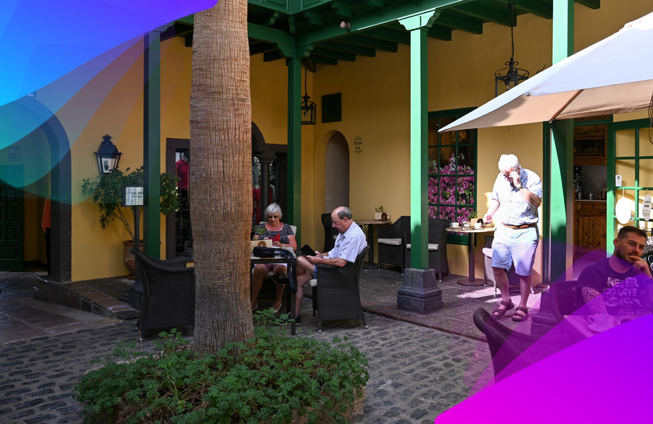 a few older people sitting on a hotel patio