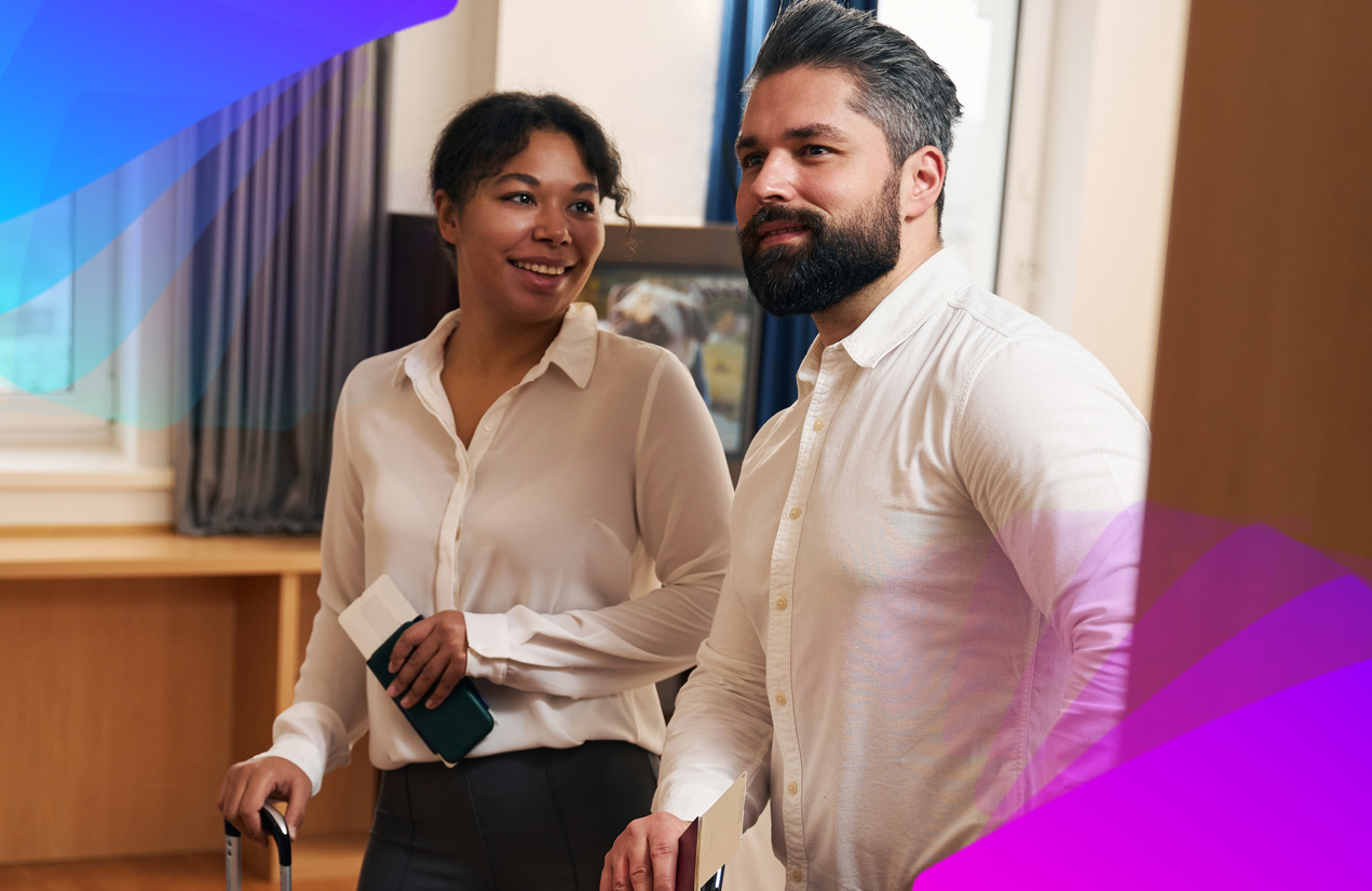A Man and a woman walking into a hotel with passports in hand