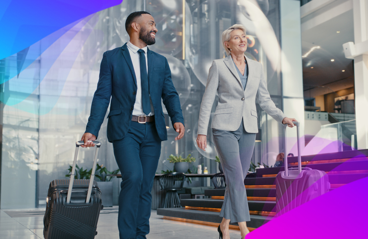 two people walking into a hotel with suitcases