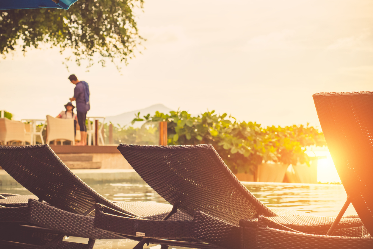 two people at a pool at sunset