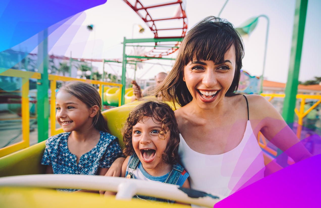 Woman riding a roller coaster with two small children