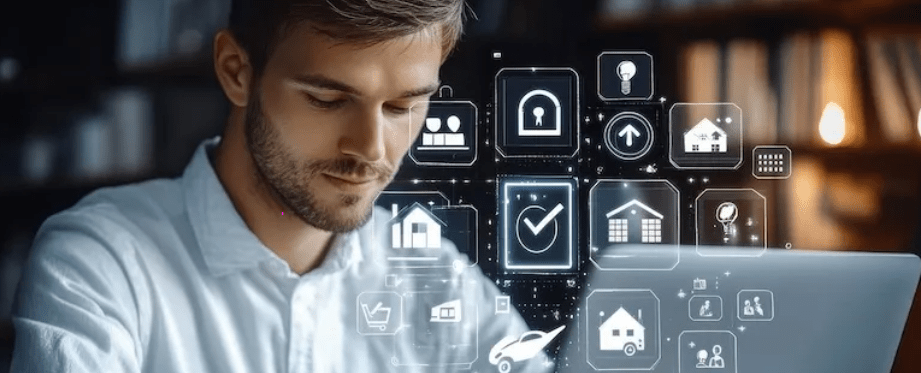man looking at his computer with travel elements floating in the air